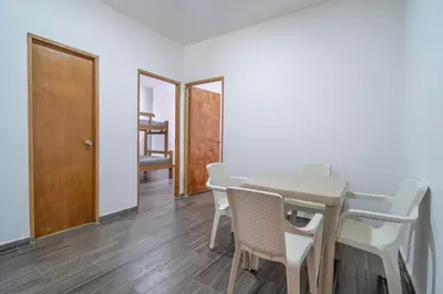 a dining room with a table and chairs at Casa Vianca Beach in Estación El Salto