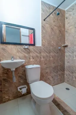 a bathroom with a toilet and a sink and a shower at Casa Vianca Beach in Estación El Salto