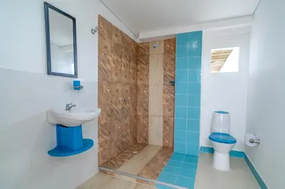 a bathroom with a shower and a sink at Casa Vianca Beach in Estación El Salto