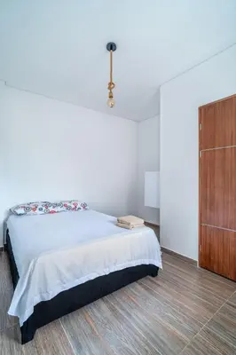 a white bedroom with a bed and a dresser at Casa Vianca Beach in Estación El Salto