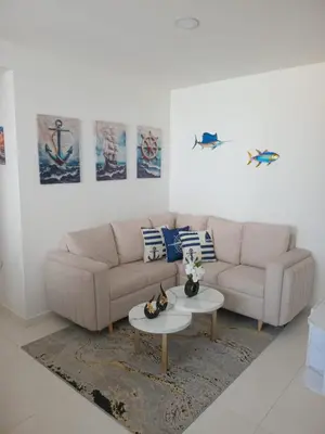 a living room with a couch and a table at Conjunto Residencial Caribe Campestre in Coveñas