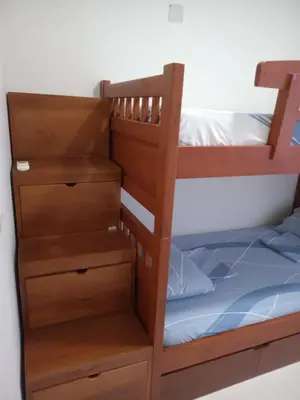 a bunk bed with a ladder and drawers at Conjunto Residencial Caribe Campestre in Coveñas