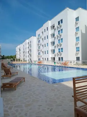 a large swimming pool in front of a building at Conjunto Residencial Caribe Campestre in Coveñas