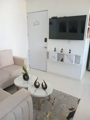 a living room with a couch and a tv at Conjunto Residencial Caribe Campestre in Coveñas