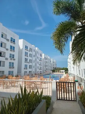 a view of a pool at a resort with tables and chairs at Conjunto Residencial Caribe Campestre in Coveñas