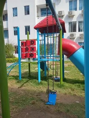 a playground with a slide in a park at Conjunto Residencial Caribe Campestre in Coveñas