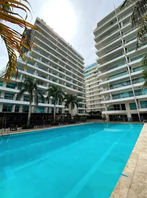 a swimming pool in front of two large buildings at Sonesta Apartamento en Cartagena in Cartagena de Indias
