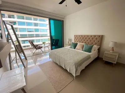 a bedroom with a bed and a large window at Sonesta Apartamento en Cartagena in Cartagena de Indias