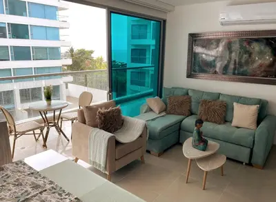 a living room with a couch and a table at Sonesta Apartamento en Cartagena in Cartagena de Indias