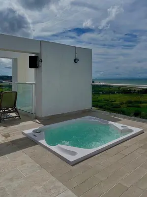a hot tub on a patio with a view of the ocean at Exclusivo Apto En Dominique Cartagena in Cartagena de Indias