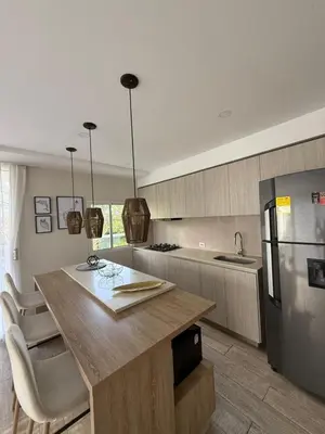 a kitchen with a counter and a refrigerator at Exclusivo Apto En Dominique Cartagena in Cartagena de Indias