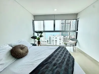 a bedroom with a large bed with a large window at magnoloft1104 in Cartagena de Indias