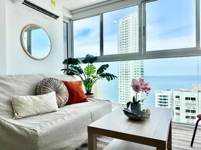 a living room with a couch and a large window at magnoloft1104 in Cartagena de Indias