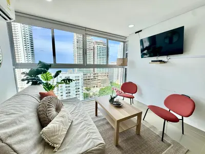a living room with a couch and a large window at magnoloft1104 in Cartagena de Indias