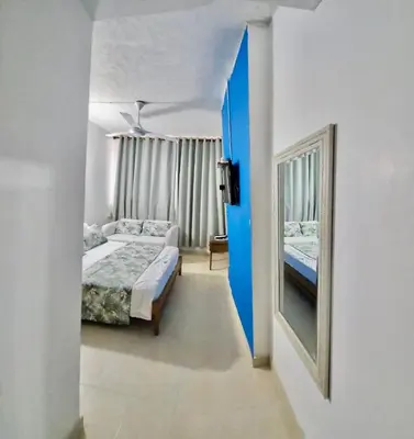 a hallway with two beds and a mirror in a room at Apartamento playa Bocagrande Los Delfines Cartagena in Cartagena de Indias