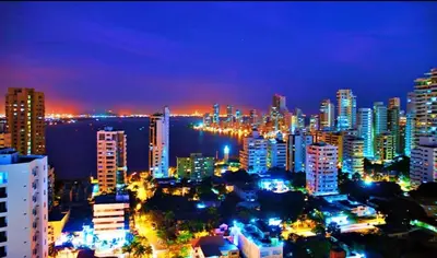 a city lit up at night with buildings at Apartamento playa Bocagrande Los Delfines Cartagena in Cartagena de Indias
