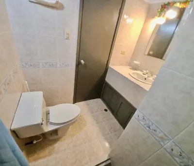 a bathroom with a toilet and a sink at Apartamento playa Bocagrande Los Delfines Cartagena in Cartagena de Indias