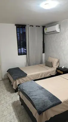 a room with three beds in a room at Apartamento 84 - 2 habitaciones in Barranquilla