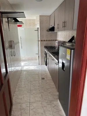 a kitchen with a refrigerator and a stove at Apartamento 84 - 2 habitaciones in Barranquilla