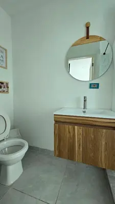 a bathroom with a toilet and a sink and a mirror at Loft MR1-4G facing the sea in a high level neighborhood in Cartagena de Indias