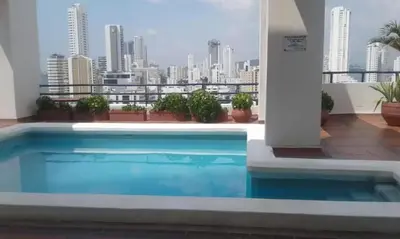 a swimming pool on top of a building with a city skyline at Loft MR1-4G facing the sea in a high level neighborhood in Cartagena de Indias