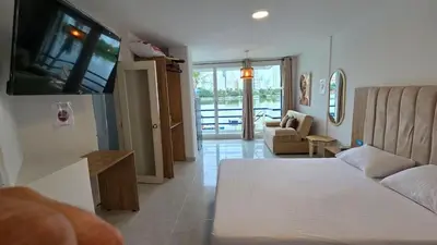 a living room with a bed and a couch at Loft MR1-4G facing the sea in a high level neighborhood in Cartagena de Indias