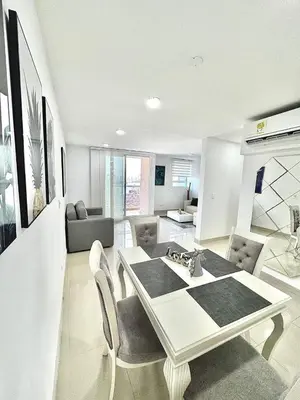 a living room with a white table and chairs at Lujoso alojamiento empresarial en Cartagena in Cartagena de Indias
