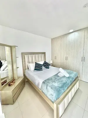 a bedroom with a large bed and a mirror at Excepcional apartamento en zona de negocios in Cartagena de Indias