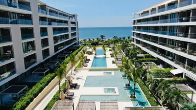 an aerial view of a resort with a swimming pool and the ocean at Spectacular Beachfront Apartment in Cartagena de Indias