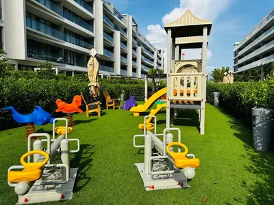 a playground with colorful play equipment on the grass at Spectacular Beachfront Apartment in Cartagena de Indias