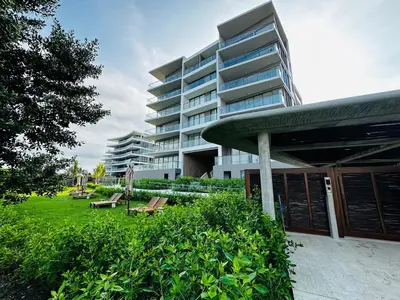 a large apartment building with benches in front of it at Spectacular Beachfront Apartment in Cartagena de Indias