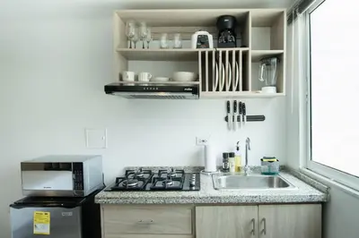 a kitchen with a sink and a microwave at Serene Bay by Wynwood House in Cartagena de Indias