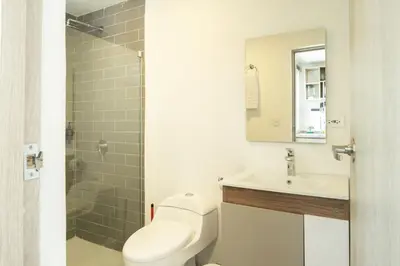 a bathroom with a toilet and a sink and a shower at Serene Bay by Wynwood House in Cartagena de Indias