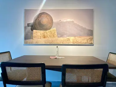 a dining room table with a picture on the wall at Serene Bay by Wynwood House in Cartagena de Indias
