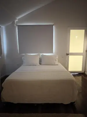 a white bed with two pillows in a room at Playa Banana Manzanillo del Mar in Cartagena de Indias