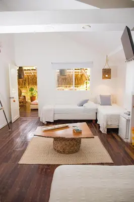 a living room with two beds and a coffee table at Playa Banana Manzanillo del Mar in Cartagena de Indias