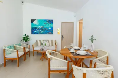 a dining room with a wooden table and chairs at Mishka Hotel Boutique Habitación 103 in Cartagena de Indias