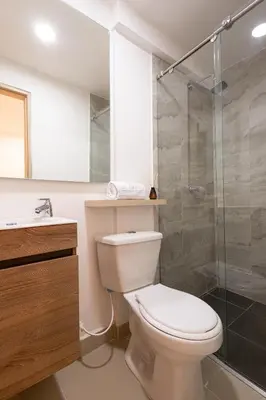 a bathroom with a toilet and a glass shower at Mishka Hotel Boutique Habitación 103 in Cartagena de Indias
