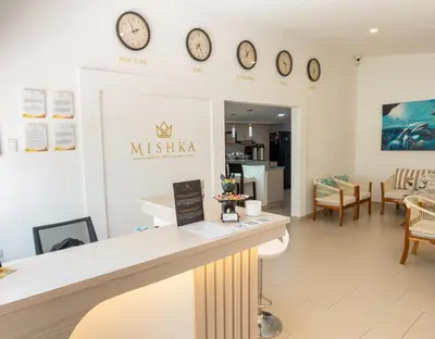 a salon with clocks on the wall and a counter at Mishka Hotel Boutique Habitación 103 in Cartagena de Indias