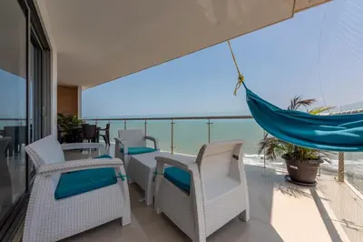 a balcony with a hammock and a view of the ocean at The best Luxury Suite in Cartagena in Cartagena de Indias