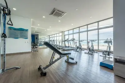a gym with a row of treadmills and machines at The best Luxury Suite in Cartagena in Cartagena de Indias