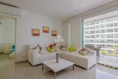 a living room with two white couches and a table at Morros Ultra, Beachfront & 2 Bedrooms by Inmobiliaria MFR in Cartagena de Indias
