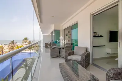 a living room with a balcony with a table and chairs at Morros Ultra, Beachfront & 2 Bedrooms by Inmobiliaria MFR in Cartagena de Indias
