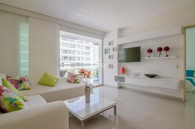 a living room with a white couch and a table at Morros Ultra, Beachfront & 2 Bedrooms by Inmobiliaria MFR in Cartagena de Indias
