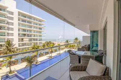 a balcony with chairs and a table and a view of the beach at Morros Ultra, Beachfront & 2 Bedrooms by Inmobiliaria MFR in Cartagena de Indias