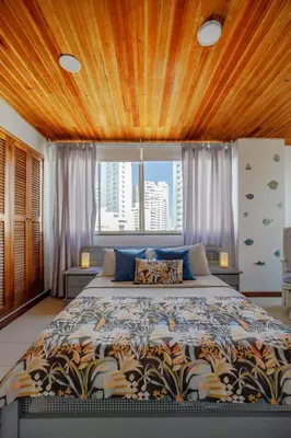 a bedroom with a large bed in front of a window at Spacious apartment in Bocagrande near the sea in Cartagena de Indias