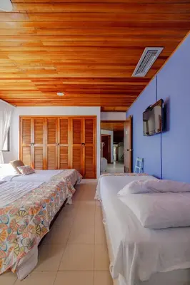 two beds in a room with wooden ceilings at Spacious apartment in Bocagrande near the sea in Cartagena de Indias
