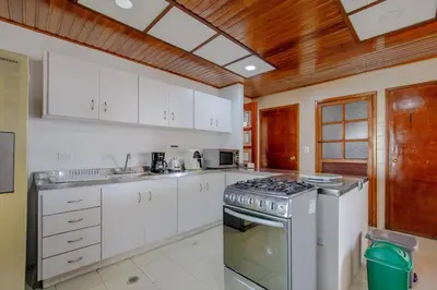 a kitchen with white cabinets and a stove top oven at Spacious apartment in Bocagrande near the sea in Cartagena de Indias