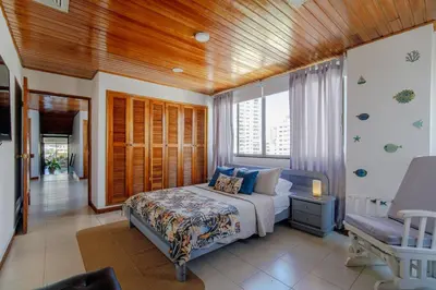 a bedroom with a bed and a window at Spacious apartment in Bocagrande near the sea in Cartagena de Indias
