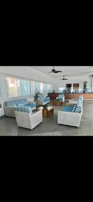 a living room with white couches and blue chairs at Tu lugar favorito en Cartagena in Cartagena de Indias